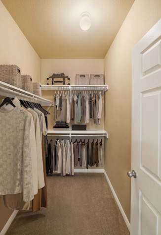 Walk-in closet with built-in wood shelves at Camden Brushy Creek apartments in Cedar Park, TX