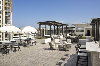 Eighth-Floor Rooftop Terrace with BBQ Grills and expansive seating at Camden Central Apartments in St. Petersburg, Florida.