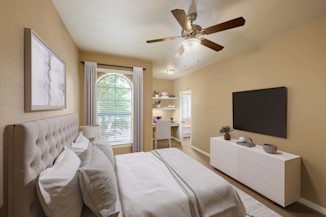 Bedroom with built-in desk and shelves plus spacious walk-in closet at Camden Brushy Creek apartments in Cedar Park, TX
