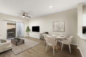 Open concept dining and living room with ceiling fan wood style flooring and patio