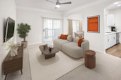 A contemporary style open-concept living room with a lighted ceiling fan at Camden Overlook apartments in Raleigh, NC. 