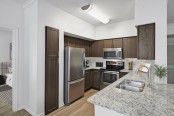 Contemporary-style kitchen with stainless steel appliances at Camden Farmers Market Apartments in Dallas, TX