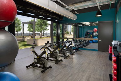 Fitness center spin studio with doors to the relaxation courtyard