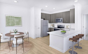 Newly renovated kitchen and dining space at Camden Town Square apartments in Kissimmee, FL