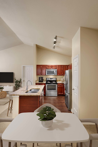 Dining area and kitchen with vaulted ceilings at Camden Brushy Creek apartments in Cedar Park, TX