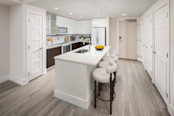 Contemporary style kitchen with white appliances and an island at Camden NoMa Apartments in Washington, DC. 