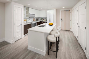 Contemporary style kitchen with white appliances and an island at Camden NoMa Apartments in Washington, DC. 