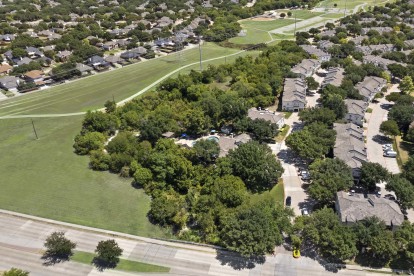 Aerial view of Camden Legacy Creek apartments in Plano, TX bordering park and trail