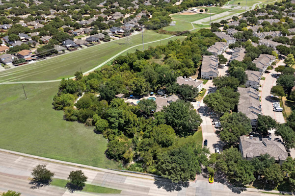 Aerial view of Camden Legacy Creek apartments in Plano, TX bordering park and trail