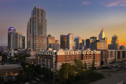 Camden Cotton Mills at night with views of Uptown Charlotte