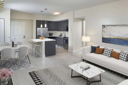 Open-concept living, dining, and kitchen at Camden Pier District high-rise apartments in St. Petersburg, FL