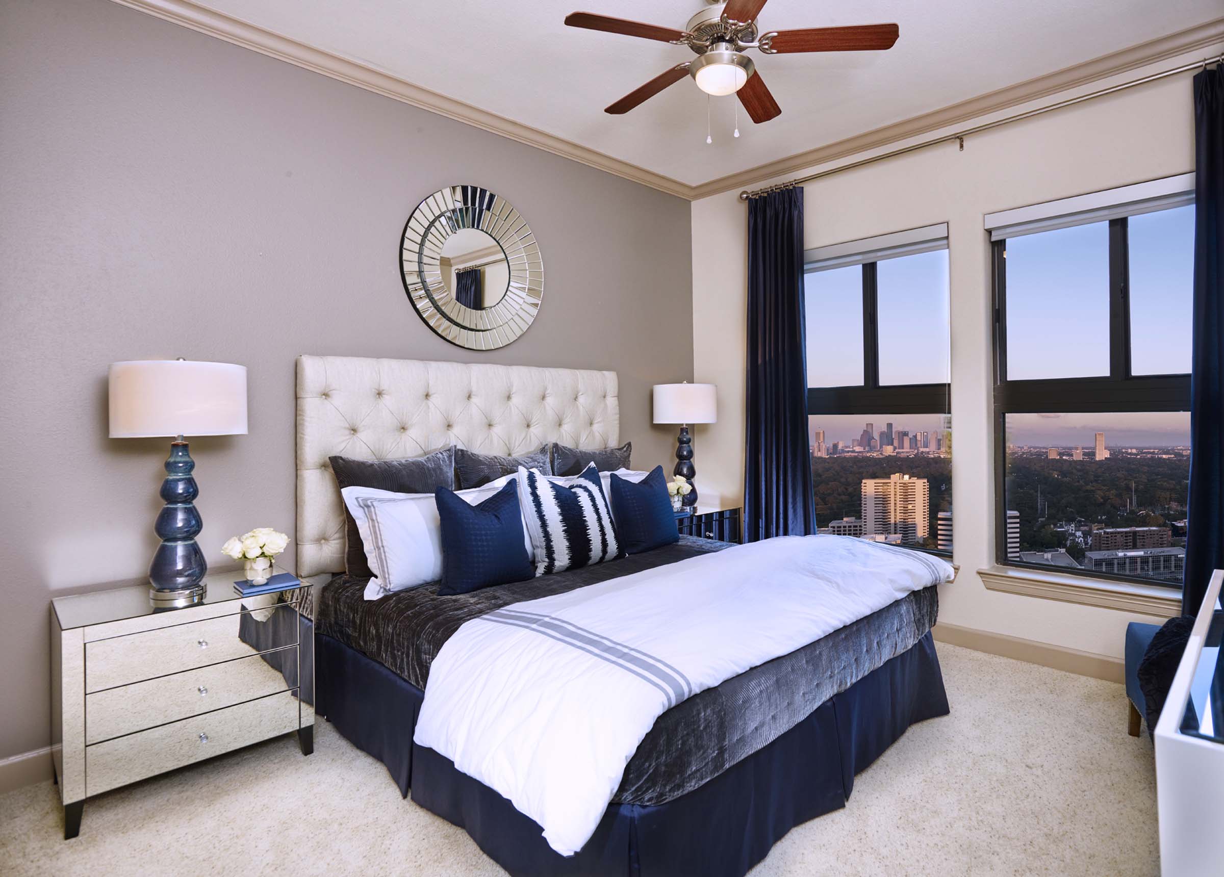 Bedroom with crown molding carpet flooring high ceilings and ceiling fan