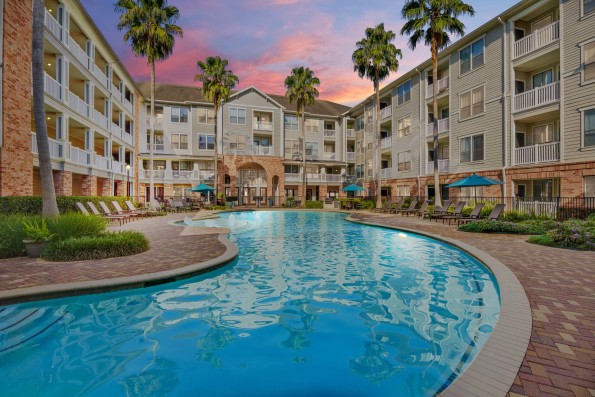 Resort-style swimming pool at dusk at Camden Heights Apartments in Houston, TX