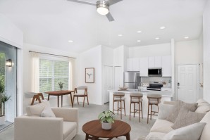 Open-concept living room, kitchen, and dining area at Camden World Gateway apartments in Orlando, FL