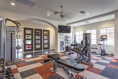 Fitness center with weight machines and dumbbells and stationary bikes