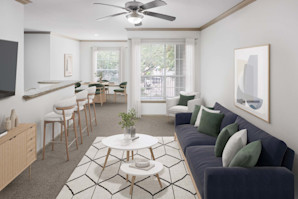 Camden Greenway apartment homes in Houston, TX living room and dining room with plush carpet and lighted ceiling fan