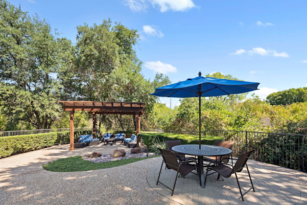 Poolside covered patio and table at Camden Legacy Creek apartments in Plano, TX