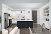 Bright contemporary finishes kitchen with island and gas range and goose neck faucet