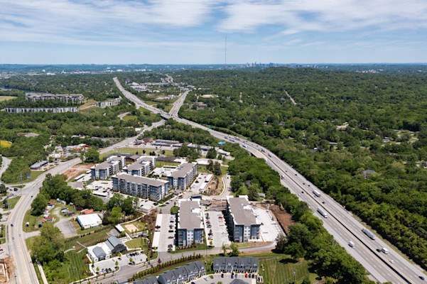 Aerial view of community off Charlotte Pike with Nashville skyline in the background at Camden West Nashville apartments in Nashville, TN