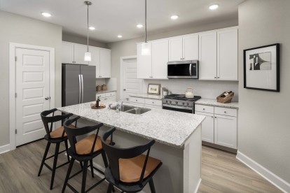 Kitchen with large island and seating at Camden Long Meadow Farms homes for rent in Richmond, TX