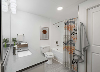 Bathroom with quartz countertop and garden bathtub at Camden Heights in Houston, TX