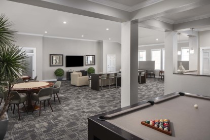 Resident game lounge with poker tables and billiards at Camden Greenway Apartments in Houston, TX