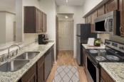 kitchen with granite countertops and stainless steel appliances at Camden Midtown Apartments in Houston, TX