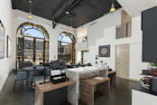 Commercial work space with arched windows under loft ceiling