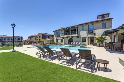 Resort style swimming pool with grass and sundeck