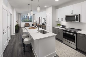 Desert modern style kitchen island with barstool seating and stainless steel appliances gray vein quartz counters