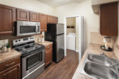 Laundry room with stainless steel appliances and laundry room at Camden Buckingham apartments in Richardson, Tx