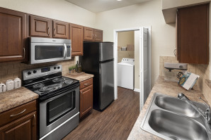 Laundry room with stainless steel appliances and laundry room at Camden Buckingham apartments in Richardson, Tx