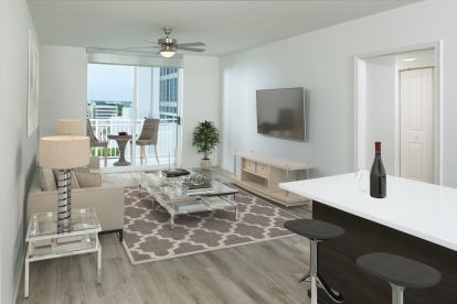 Living room and balcony with city or pool view