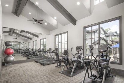 Fitness center with cardio equipment at Camden Woodson Park in Houston, TX