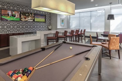 24 hr resident game lounge with pool billiards table flat screen tvs and entertaining kitchen