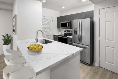 camden tuscany apartments san diego ca kitchen with barstool seating and stainless steel appliance