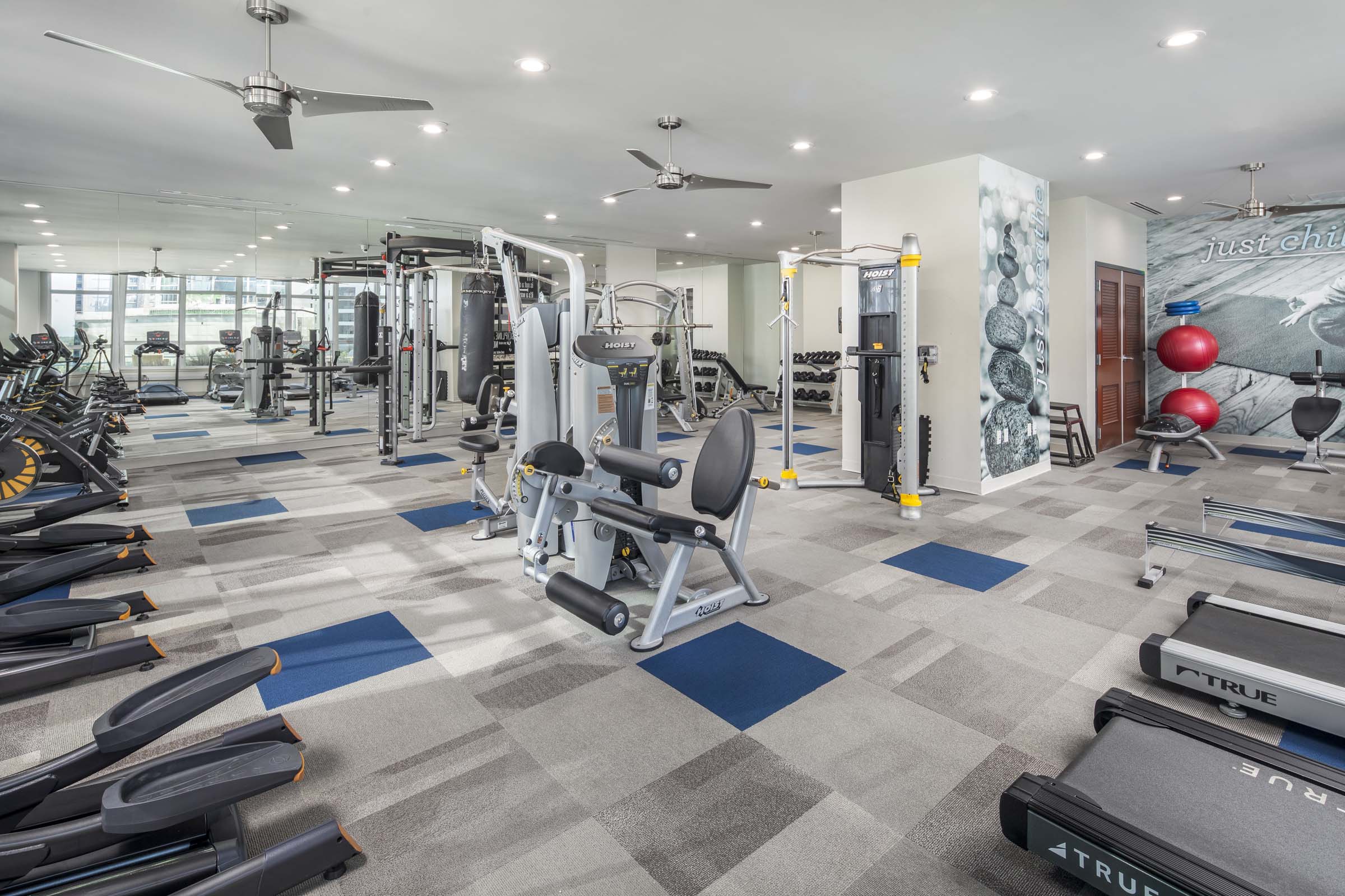 24-hour fitness center with various cardio and strength machines and equipment at Camden Rainey Street apartments in Austin, TX