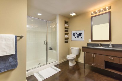 Bathroom with walk in glass enclosed shower and vanity with ample storage