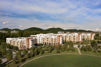 Exterior view of Camden Franklin Park with hills in the background and local park nearby.