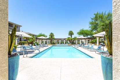 Swimming pool with deck chairs