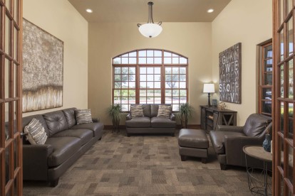 Second clubhouse lounge room with couches at Camden Riverwalk apartments in Grapevine, TX