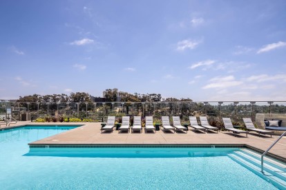 Camden Hillcrest Apartments San Diego CA Expansive pool and sun deck with loungers overlooking canyon views to the ocean