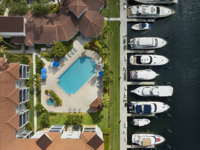 Downward view of pool and marina at Camden Aventura apartments in Aventura, Florida.