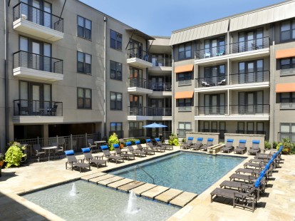 Pool and sundeck with plenty of seating at Camden Belmont apartments in Dallas, TX