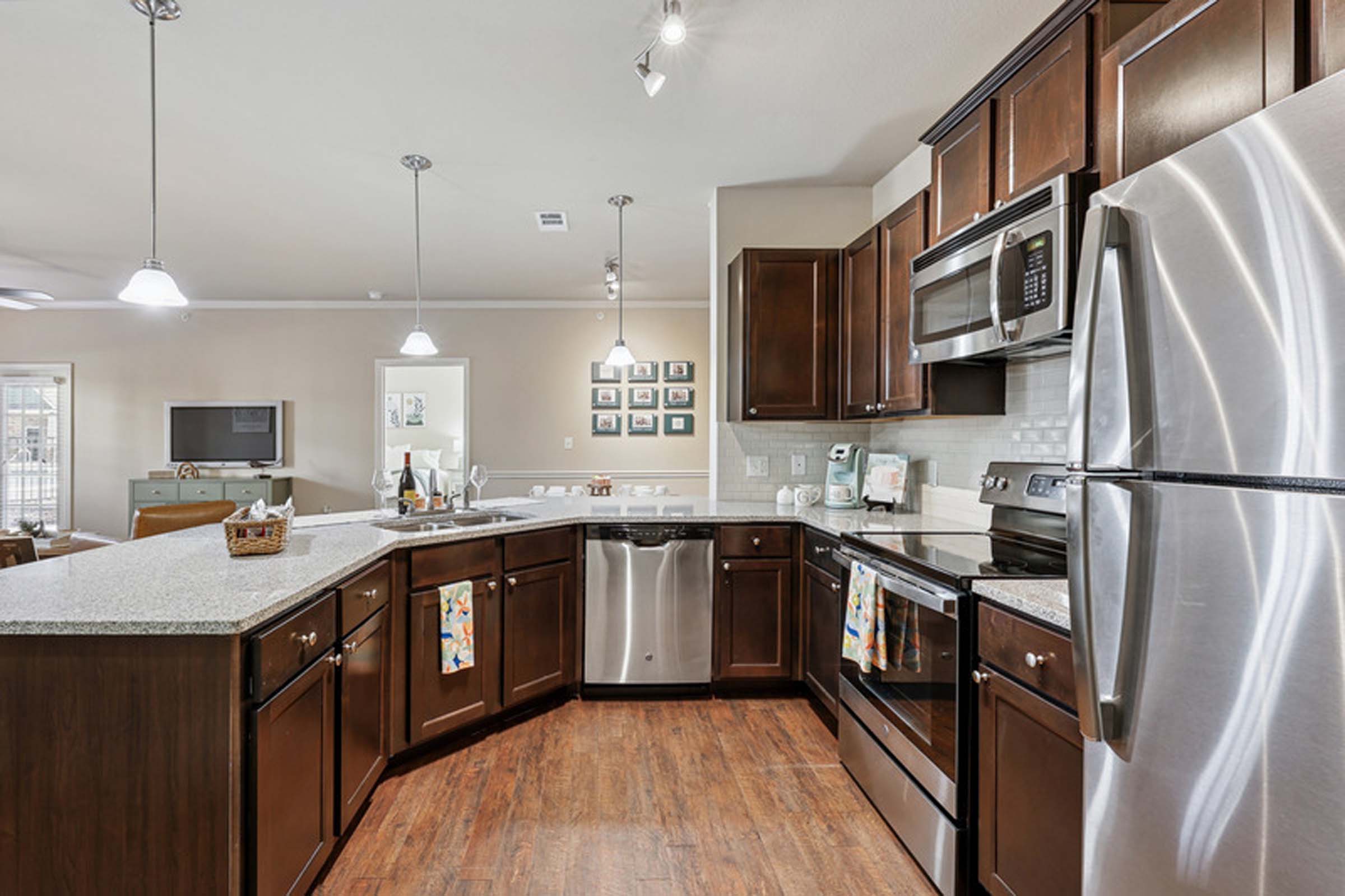 Kitchen with espresso cabinets and stainless steel appliances at Camden Franklin apartments in Franklin, TN