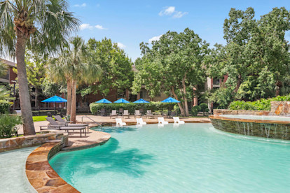 Resort style pool with tanning shelf wifi water features and grills at Camden Holly Springs Apartments in Houston, TX