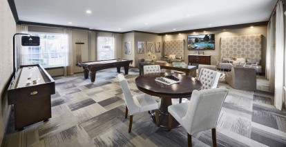 Resident game room with billiards and shuffleboard at Camden Midtown Apartments in Houston, TX