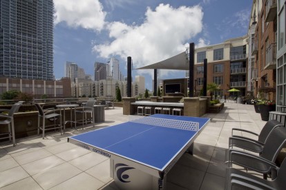 Rooftop outdoor lounge with ping pong table and tvs