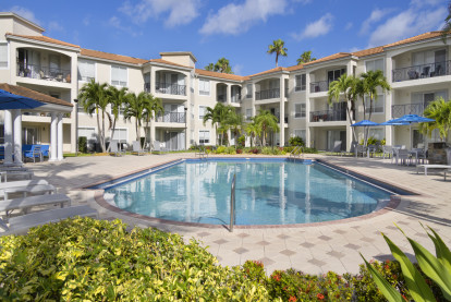 Pool overlooking marina with expansive deck space and lounging areas at Camden Aventura apartments in Aventura, Florida.