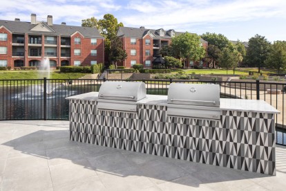 BBQ grills by the pool at Camden Vanderbilt apartments in Houston, TX